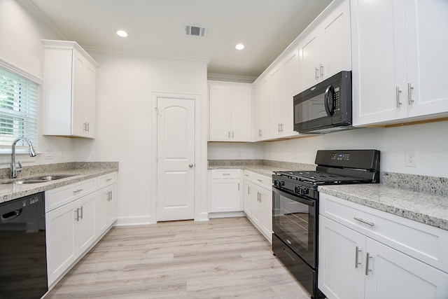 6727 Utah St, Houston, TX 77091 - kitchen with black appliances, a sink, crown molding, white cabinetry, and light wood-type flooring