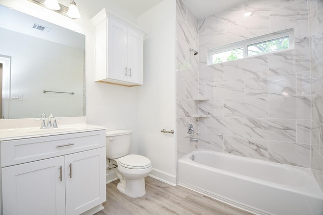 6727 Utah St, Houston, TX 77091 - full bath featuring vanity, toilet, wood finished floors, bathtub / shower combination, and baseboards