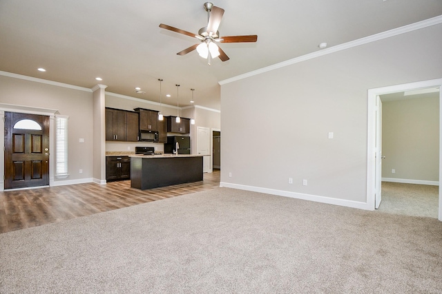 6519 Utah St, Houston, TX 77091 - unfurnished living room with a ceiling fan, light carpet, crown molding, baseboards, and recessed lighting