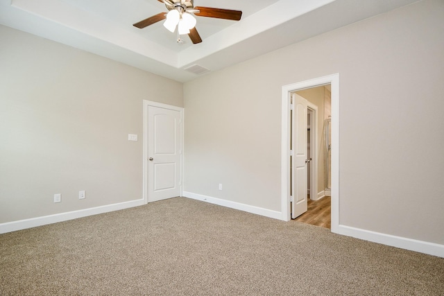 6519 Utah St, Houston, TX 77091 - unfurnished room featuring light colored carpet, ceiling fan, a raised ceiling, and baseboards