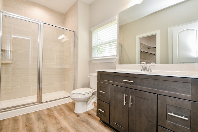 6519 Utah St, Houston, TX 77091 - bathroom featuring toilet, vanity, a stall shower, and wood finished floors