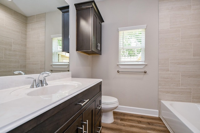 6519 Utah St, Houston, TX 77091 - bathroom featuring vanity, toilet, wood finished floors, baseboards, and  shower combination