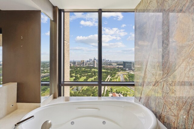 2001 Holcombe Blvd Unit Ph4, Houston, TX 77030 - bathroom featuring plenty of natural light, a whirlpool tub, and a view of city