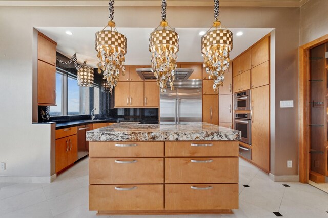 2001 Holcombe Blvd Unit Ph4, Houston, TX 77030 - kitchen featuring stainless steel appliances, a chandelier, a kitchen island, a warming drawer, and baseboards