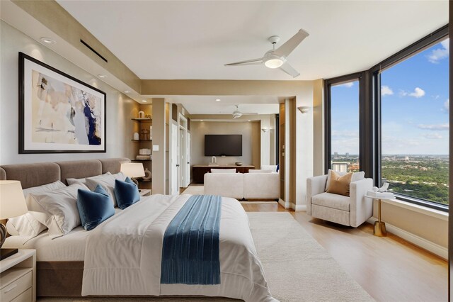 2001 Holcombe Blvd Unit Ph4, Houston, TX 77030 - bedroom featuring light wood-style flooring, baseboards, and ceiling fan