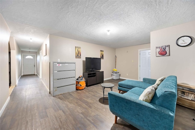 1206 Dewalt St, Houston, TX 77088 - living room with baseboards, wood finished floors, and a textured ceiling