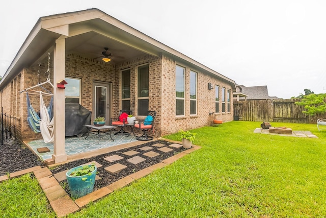 17915 Tall Chestnut St, Cypress, TX 77429 - rear view of house with ceiling fan, brick siding, a patio area, and a fire pit