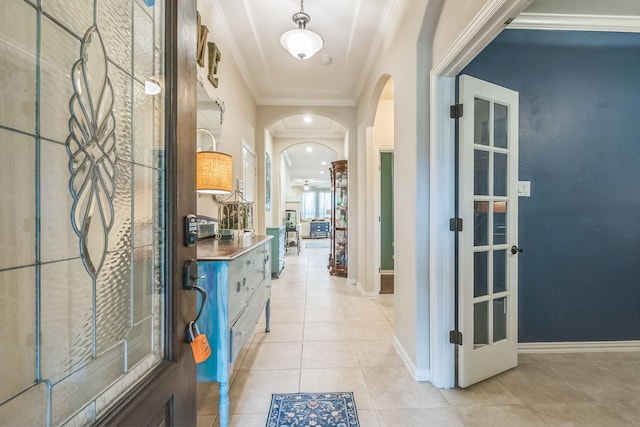 17915 Tall Chestnut St, Cypress, TX 77429 - foyer with arched walkways, light tile patterned floors, crown molding, and baseboards