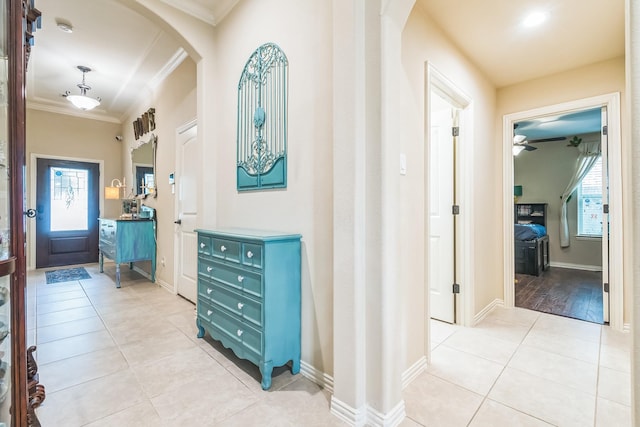 17915 Tall Chestnut St, Cypress, TX 77429 - hall featuring crown molding, arched walkways, light tile patterned floors, plenty of natural light, and baseboards