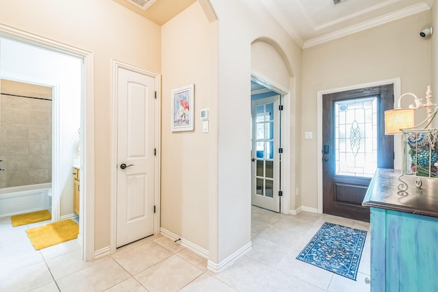 17915 Tall Chestnut St, Cypress, TX 77429 - foyer entrance with light tile patterned floors, ornamental molding, arched walkways, and baseboards