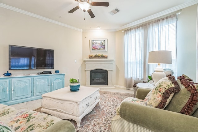17915 Tall Chestnut St, Cypress, TX 77429 - living room with ceiling fan, crown molding, a glass covered fireplace, light tile patterned flooring, and baseboards