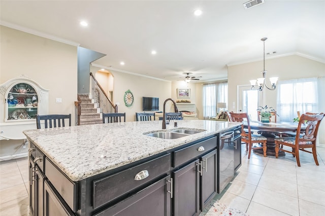 17915 Tall Chestnut St, Cypress, TX 77429 - kitchen with a sink, stainless steel dishwasher, light tile patterned flooring, a center island with sink, and ornamental molding