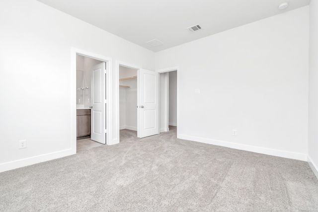 21118 Chelton Beach Dr, Cypress, TX 77433 - unfurnished bedroom featuring light carpet, baseboards, a walk in closet, a closet, and ensuite bathroom