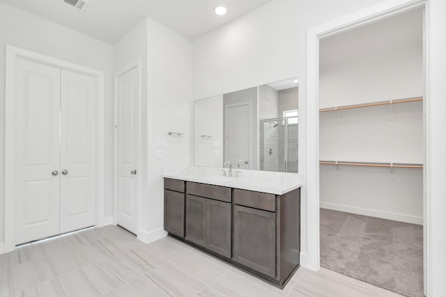 21118 Chelton Beach Dr, Cypress, TX 77433 - full bath with a shower stall, vanity, baseboards, a walk in closet, and recessed lighting
