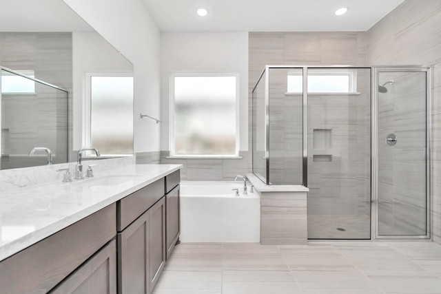 21118 Chelton Beach Dr, Cypress, TX 77433 - full bath with vanity, a stall shower, a bath, recessed lighting, and tile walls