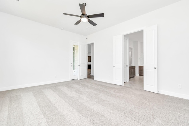 21118 Chelton Beach Dr, Cypress, TX 77433 - unfurnished bedroom featuring carpet floors, baseboards, ensuite bathroom, and ceiling fan