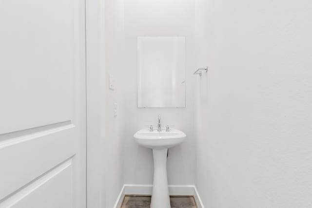 21118 Chelton Beach Dr, Cypress, TX 77433 - bathroom featuring baseboards and a sink