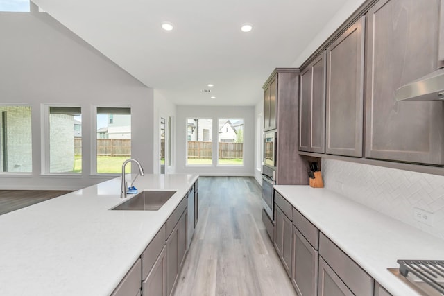 21118 Chelton Beach Dr, Cypress, TX 77433 - kitchen featuring a sink, light wood-style floors, light countertops, recessed lighting, and appliances with stainless steel finishes