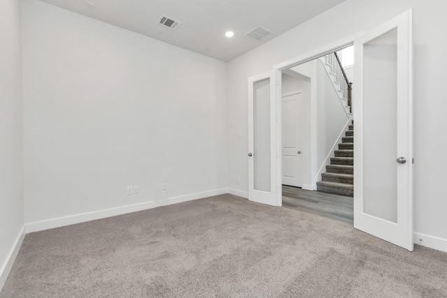 21118 Chelton Beach Dr, Cypress, TX 77433 - carpeted empty room featuring baseboards, stairs, recessed lighting, and french doors