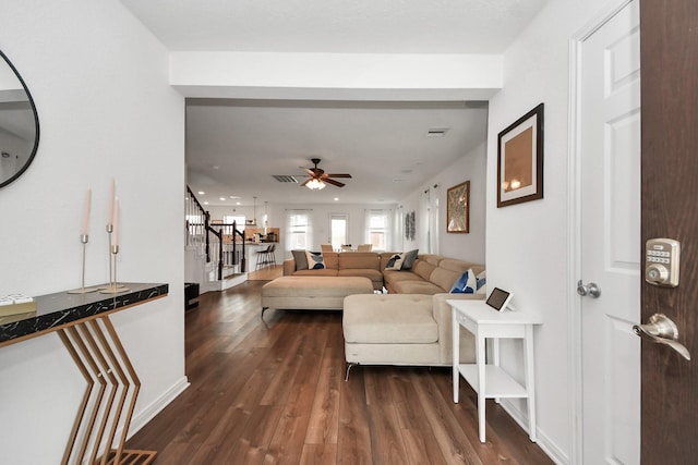16350 Oakside Hollow Ln, Houston, TX 77084 - living room with stairway, dark wood-style flooring, ceiling fan, and baseboards