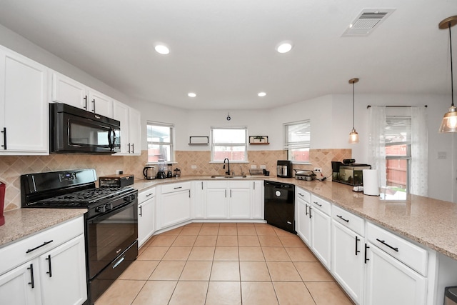 16350 Oakside Hollow Ln, Houston, TX 77084 - kitchen with black appliances, a peninsula, backsplash, white cabinets, and light stone counters