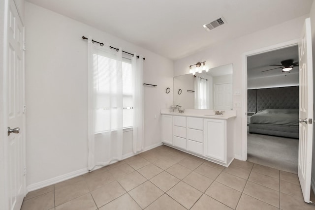 16350 Oakside Hollow Ln, Houston, TX 77084 - ensuite bathroom with double vanity, tile patterned flooring, baseboards, and ceiling fan