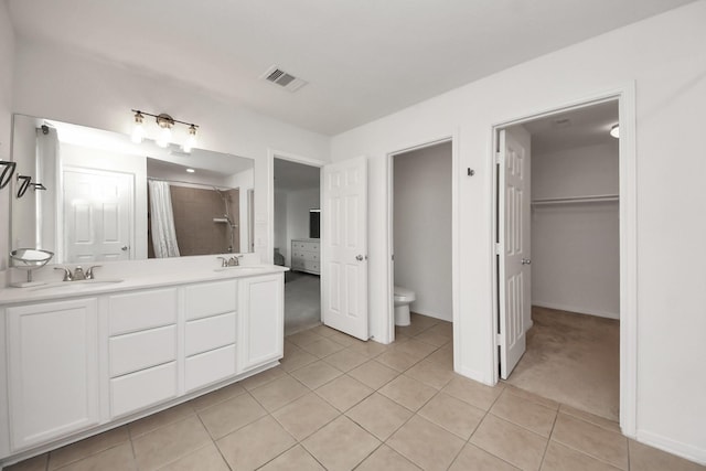 16350 Oakside Hollow Ln, Houston, TX 77084 - full bathroom with tile patterned flooring, double vanity, toilet, a shower with curtain, and a spacious closet