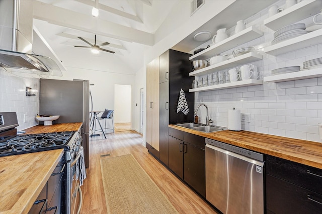 542 Arlington St, Houston, TX 77007 - kitchen featuring butcher block counters, stainless steel appliances, a sink, light wood-type flooring, and open shelves