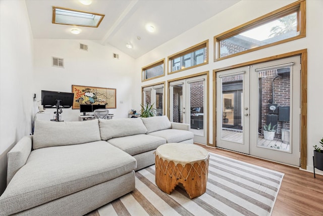 542 Arlington St, Houston, TX 77007 - living area with french doors, light wood-style floors, a skylight, beam ceiling, and high vaulted ceiling