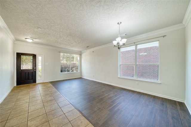 6610 Autumn Sunset Ln, Spring, TX 77379 - foyer with a chandelier, a textured ceiling, wood finished floors, crown molding, and baseboards