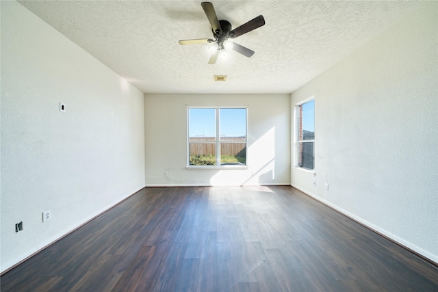 6610 Autumn Sunset Ln, Spring, TX 77379 - empty room with a textured ceiling, a ceiling fan, dark wood-style floors, and baseboards