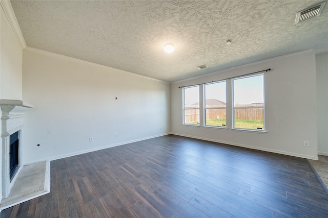 6610 Autumn Sunset Ln, Spring, TX 77379 - unfurnished living room featuring ornamental molding, a textured ceiling, dark wood-style floors, a fireplace with raised hearth, and baseboards