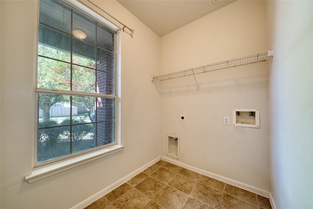 6610 Autumn Sunset Ln, Spring, TX 77379 - laundry area featuring electric dryer hookup, hookup for a washing machine, baseboards, and tile patterned floors