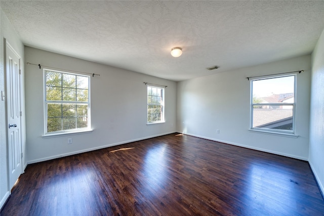 6610 Autumn Sunset Ln, Spring, TX 77379 - spare room with dark wood-style floors, baseboards, and a textured ceiling