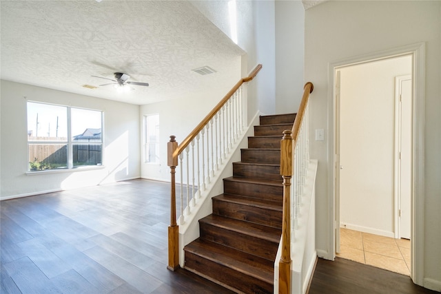 6610 Autumn Sunset Ln, Spring, TX 77379 - staircase with wood finished floors, ceiling fan, a textured ceiling, and baseboards