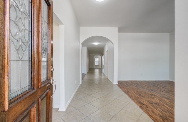 12223 Ayrshire Pl, Houston, TX 77089 - foyer entrance with arched walkways, light tile patterned flooring, and baseboards