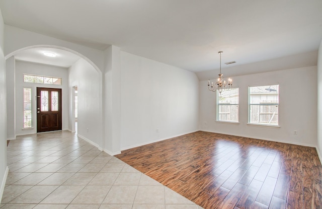 12223 Ayrshire Pl, Houston, TX 77089 - foyer with arched walkways, plenty of natural light, a chandelier, and baseboards