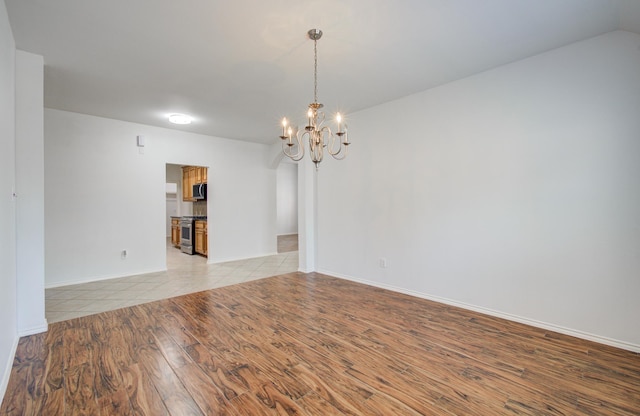 12223 Ayrshire Pl, Houston, TX 77089 - unfurnished room featuring light wood-type flooring, a chandelier, and baseboards