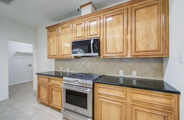12223 Ayrshire Pl, Houston, TX 77089 - kitchen featuring stainless steel appliances, backsplash, light tile patterned flooring, and dark stone counters