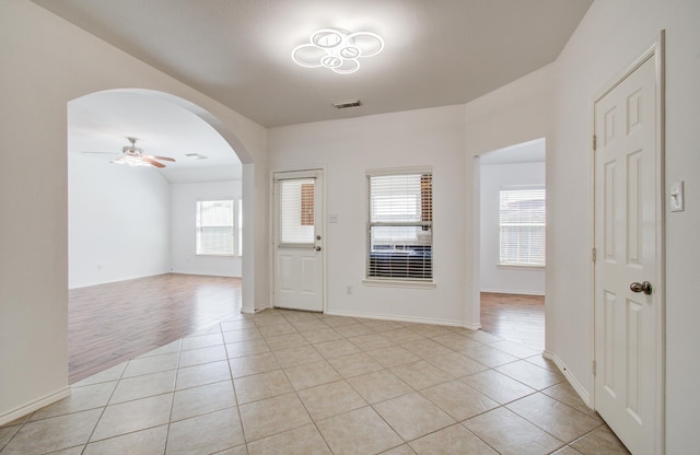 12223 Ayrshire Pl, Houston, TX 77089 - foyer entrance featuring healthy amount of natural light, arched walkways, light tile patterned floors, and a ceiling fan