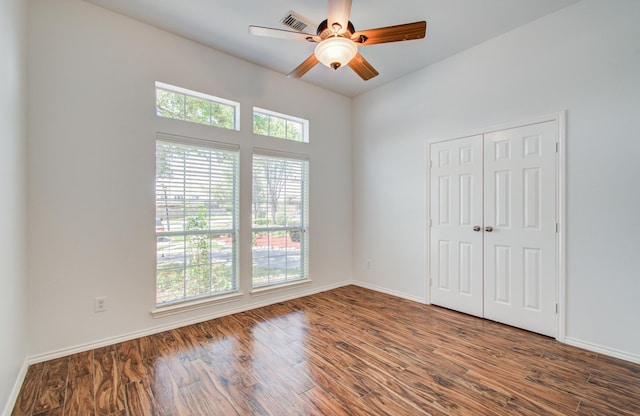12223 Ayrshire Pl, Houston, TX 77089 - unfurnished bedroom with wood finished floors, a closet, baseboards, and a ceiling fan