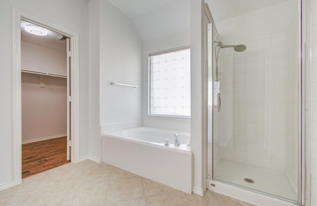 12223 Ayrshire Pl, Houston, TX 77089 - full bathroom featuring a shower stall, a garden tub, a spacious closet, tile patterned flooring, and baseboards