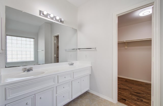 12223 Ayrshire Pl, Houston, TX 77089 - full bathroom with double vanity, a spacious closet, and baseboards