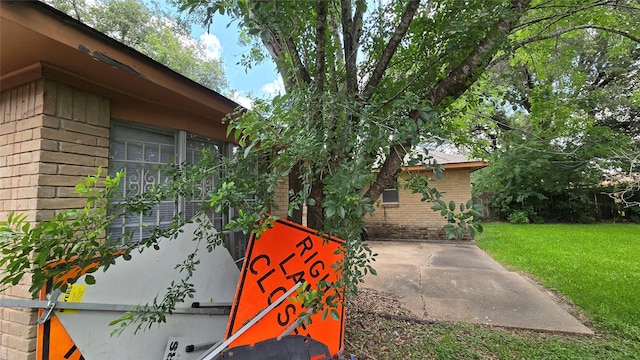 3823 Regency Dr, Houston, TX 77045 - view of home's exterior with a lawn and brick siding