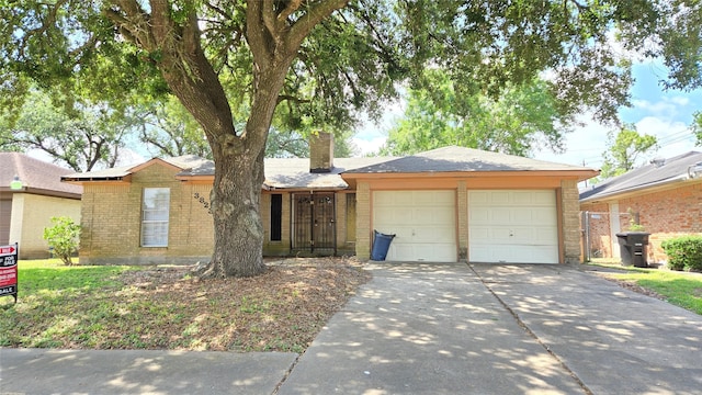 3823 Regency Dr, Houston, TX 77045 - single story home with a chimney, concrete driveway, brick siding, and a garage