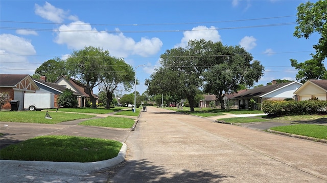 3823 Regency Dr, Houston, TX 77045 - view of concrete street with curbs, street lights, and sidewalks