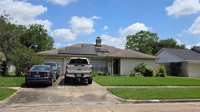 3823 Regency Dr, Houston, TX 77045 - single story home featuring driveway, a front lawn, an attached garage, solar panels, and a chimney