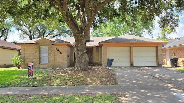 3823 Regency Dr, Houston, TX 77045 - single story home featuring a garage, concrete driveway, and brick siding