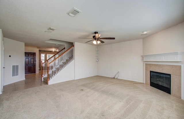17919 Royal Gate Ln, Richmond, TX 77407 - unfurnished living room featuring carpet, a fireplace, ceiling fan, stairway, and baseboards