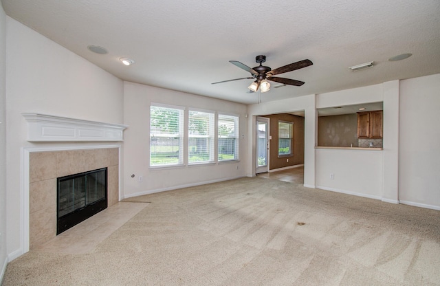 17919 Royal Gate Ln, Richmond, TX 77407 - unfurnished living room with a high end fireplace, light carpet, baseboards, and a ceiling fan